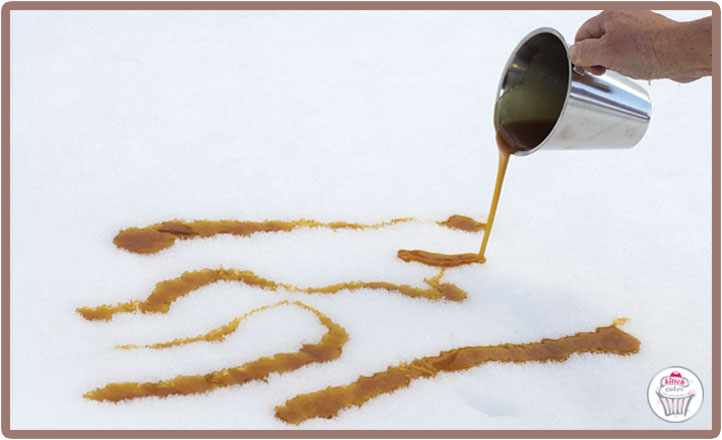 Pour lines of hot syrup onto snow.